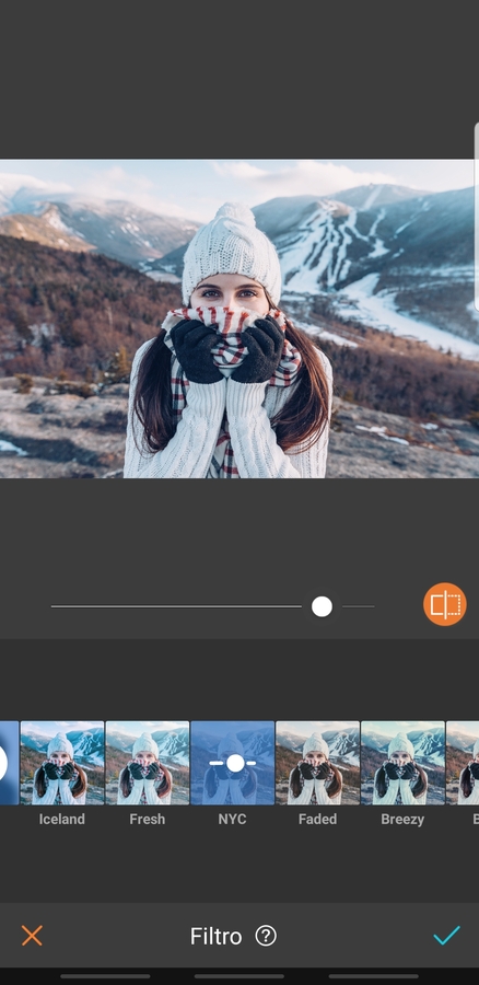 mujer en la montaña con ropa de invierno