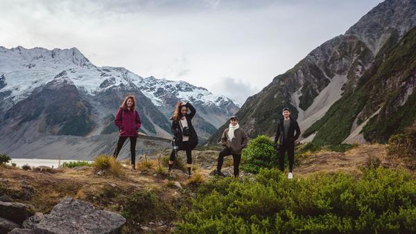 women standing on top of a mountain