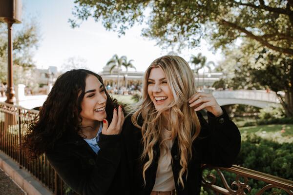 two women laughing outdoors