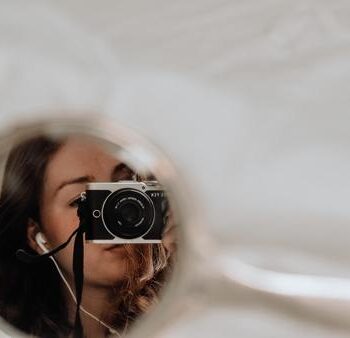 picture of a mirror of a woman holding a camera
