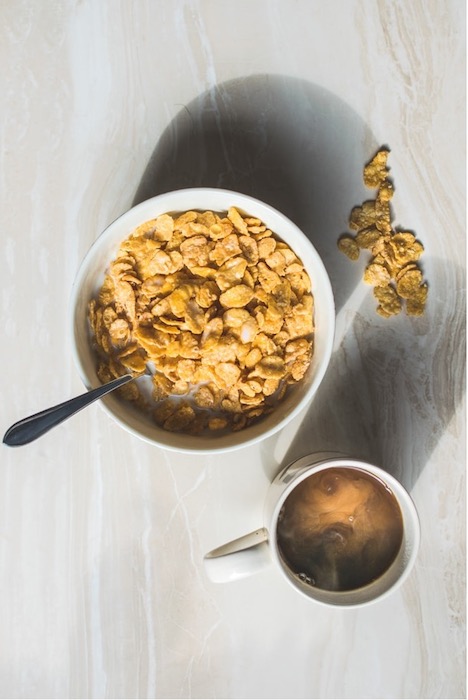 Picture of a bowl with cereal and a cup of coffee being edited by AirBrush with the Rotate Tool