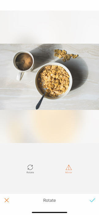Picture of a bowl with cereal and a cup of coffee being edited by AirBrush with the Rotate Tool
