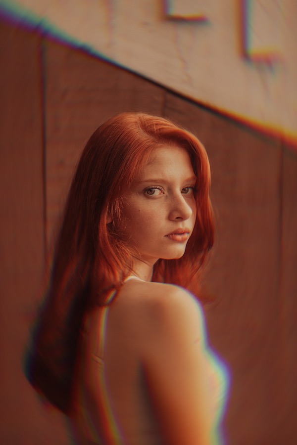 red headed woman in front of blurred background