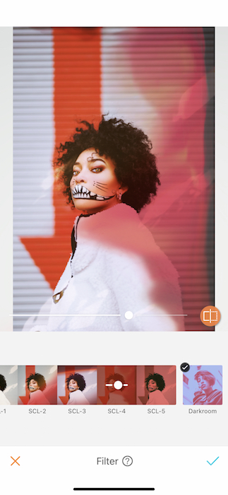 woman in a white jacket wearing Halloween makeup