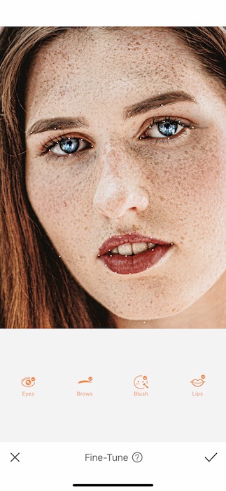 Picture of a white woman with freckles being edited by AirBrush with Fine-tune tool
