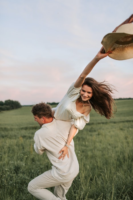 Picture of a guy holding his girlfriend in an open field