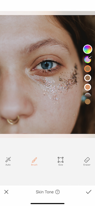 It's an image of a white girl, with blue eyes and glitter in her eyes, being edited with AirBrush App.