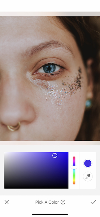 It's an image of a white girl, with blue eyes and glitter in her eyes, being edited with AirBrush App.