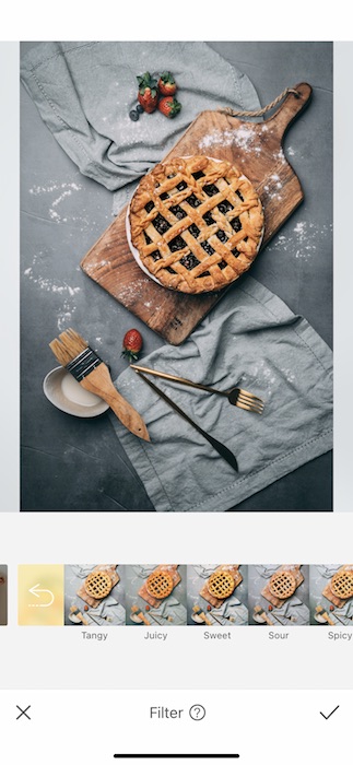 blueberry pie on cutting board with ingredients
