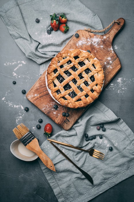edited photo of blueberry pie with ingredients