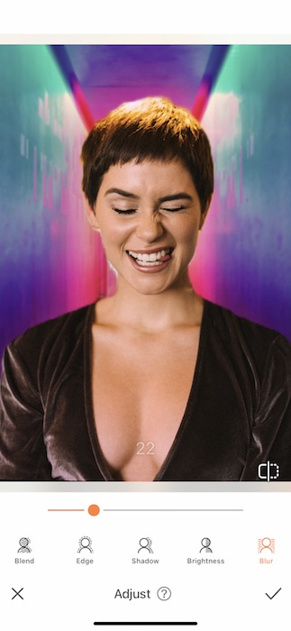 woman with a pixie haircut making a silly face in front of a colorful background