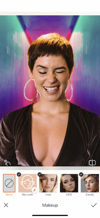 woman with a pixie haircut making a silly face in front of a colorful background