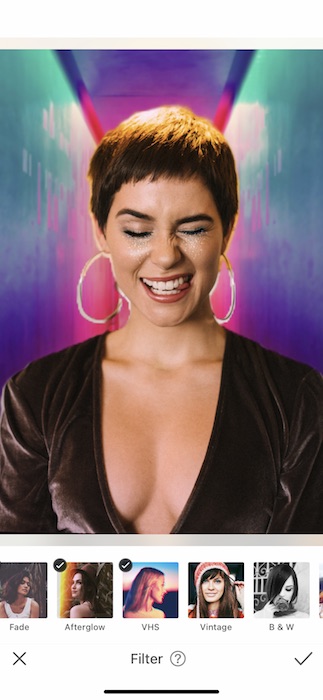 woman with a pixie haircut making a silly face in front of a colorful background