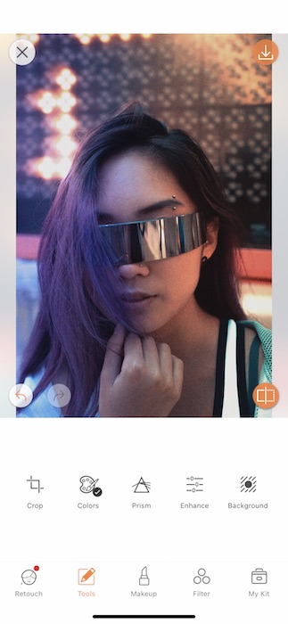 Picture of a woman with intergalactic glasses being edited by AirBrush with Prism