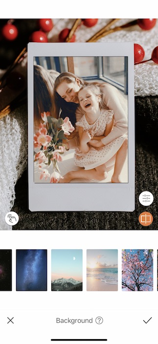 photo of mother hugging toddler daughter and laughing on an iPad with cherries background
