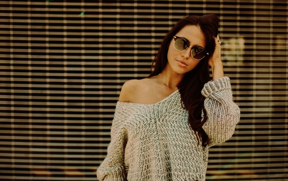 Scorpio edit of a woman wearing a grey sweater and sunglasses