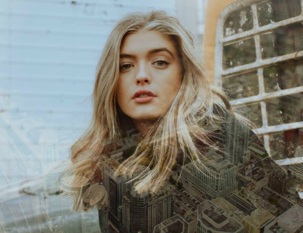 Photo of blonde woman with Metro filter creating a layer of city skyline