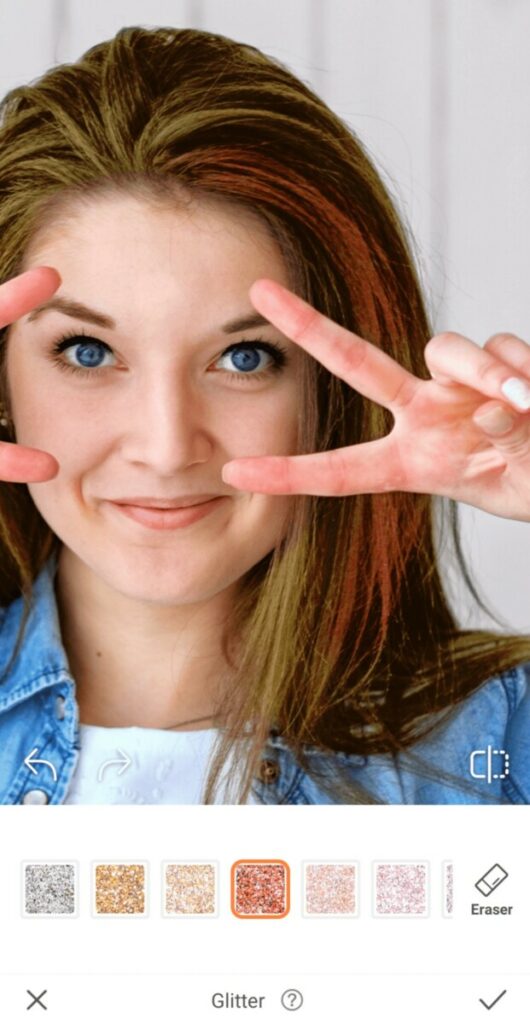 closeup of woman making peace signs over her eyes