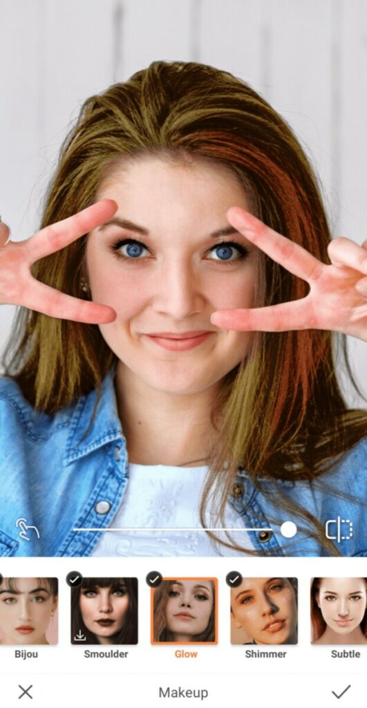 closeup of woman making peace signs over her eyes