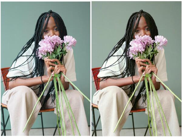 mulher negra sentada segundo um buquê de flores