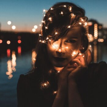 Nighttime photos of woman holding fairy lights