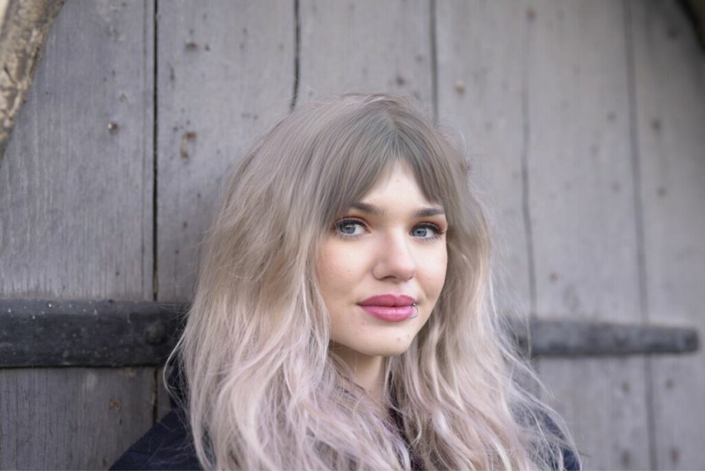 woman with blonde hair and curtain bangs