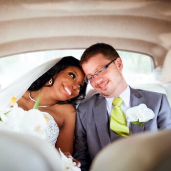 bride and groom sitting in a car