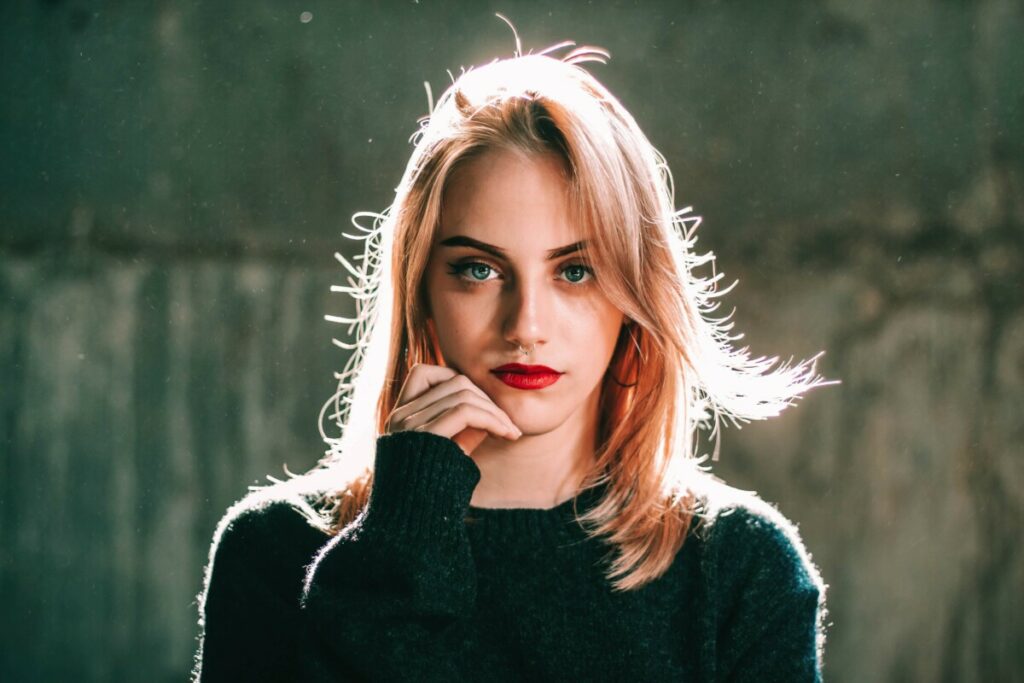 woman with red lips wearing a black sweater
