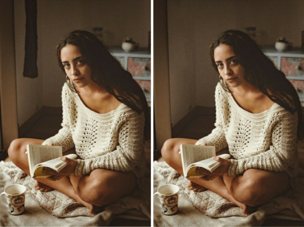 Woman wearing a white sweater reading in bed